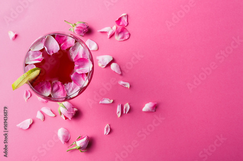 Rose cocktail in champagne glass on pink background