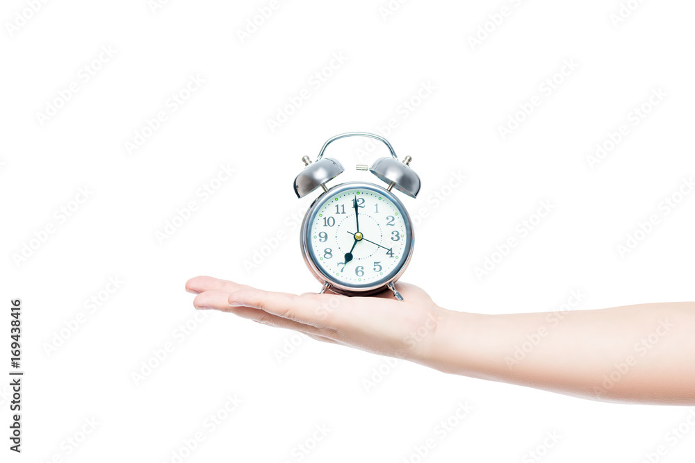 man's hand on a white background isolated with an alarm clock in retro style man's hand on a white background isolated with an alarm clock in retro style
