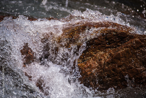 Wallpaper Mural Drops and streams of water scatter over the stone. Shevelev. Torontodigital.ca