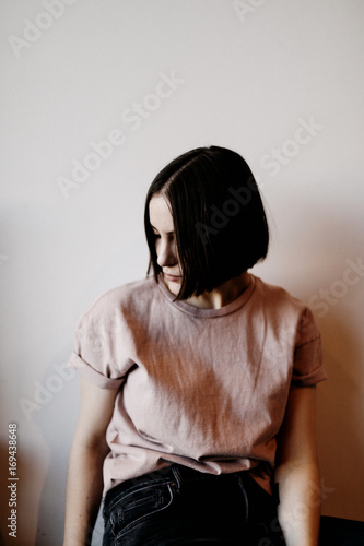 A girl in pink shirt and black jeans photo