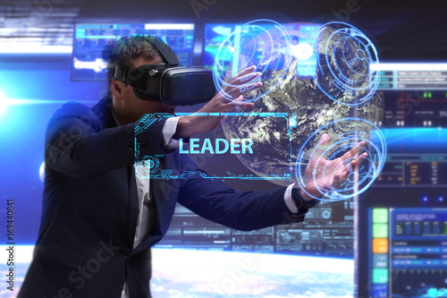 Business, Technology, Internet and network concept. Young businessman working in virtual reality glasses sees the inscription: Leader