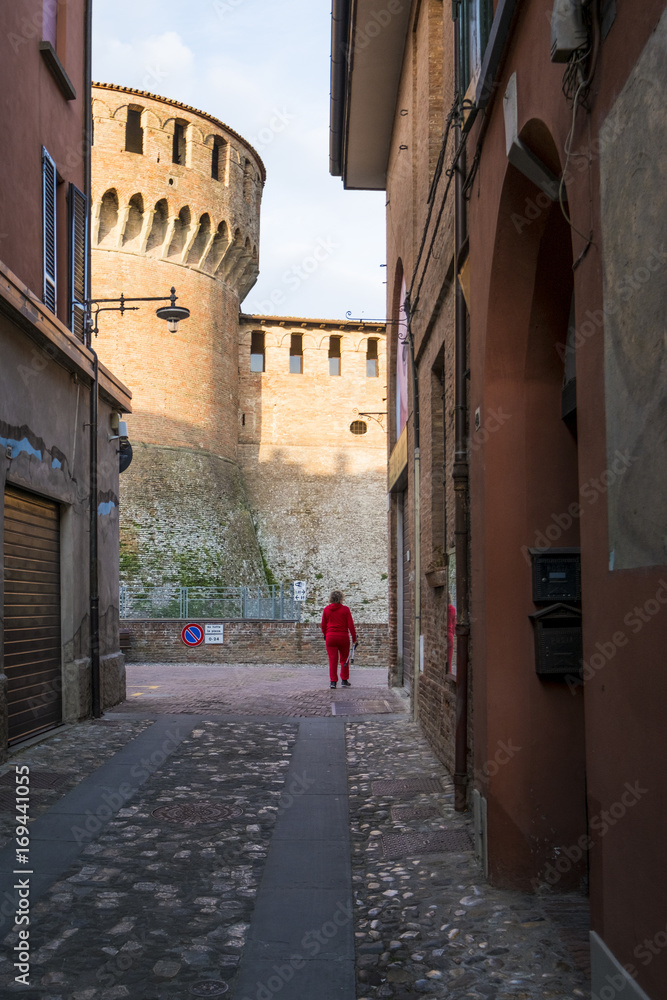 Dozza, Bologna, Emilia Romagna, Italy, Europe. The tower of a medieval fortress from alley. Dozza, Bologna, Emilia Romagna, Italy, Europe. The tower of a medieval fortress from alley.