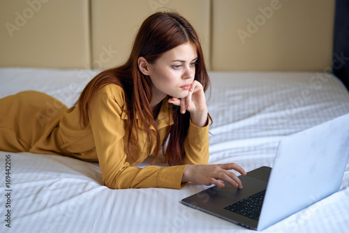 Woman is typing on laptop at home