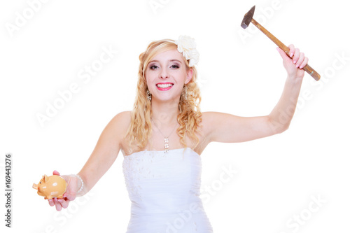 Bride trying to break piggy bank with hammer