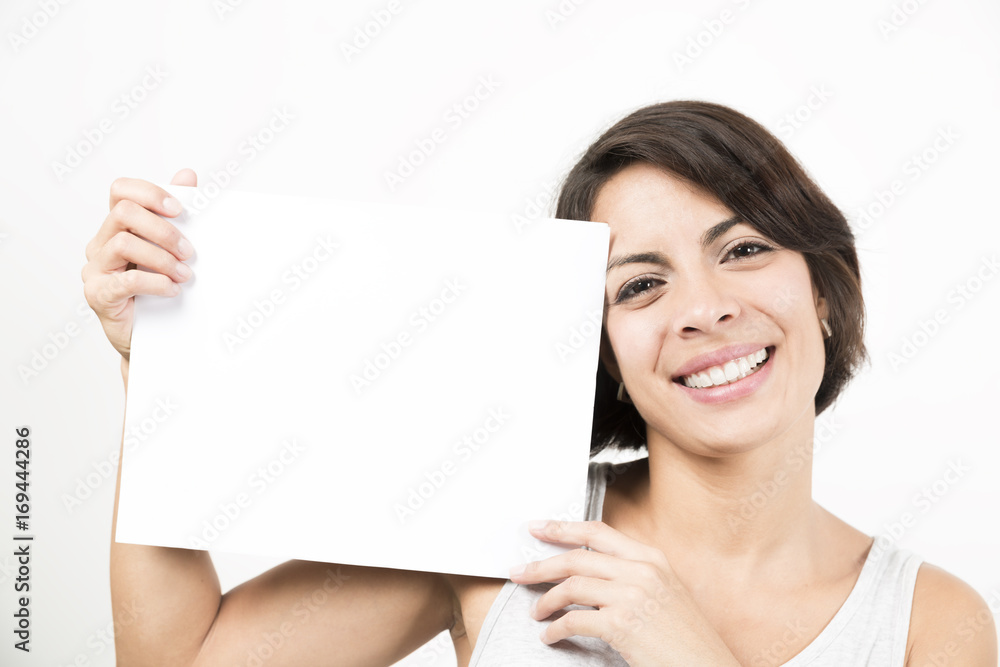 Beautiful young woman holding a blank sheet of paper Beautiful young woman holding a blank sheet of paper
