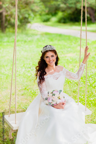 Portrait of very beautiful bride rope swing