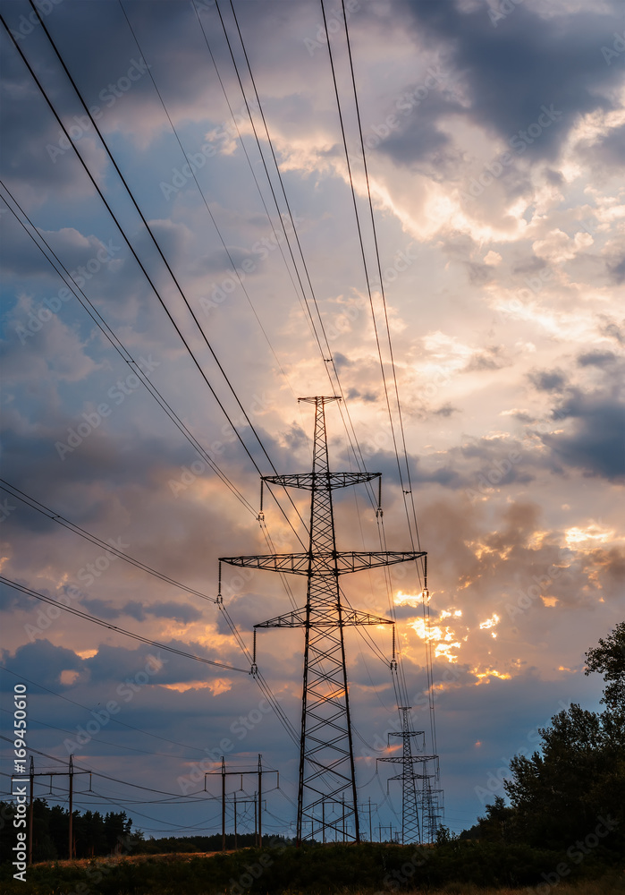 high voltage post. High-voltage tower sunset background