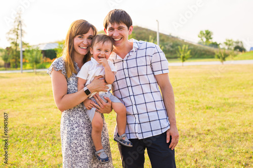 happy family walks in the field in autumn, play and have fun, bright evening light