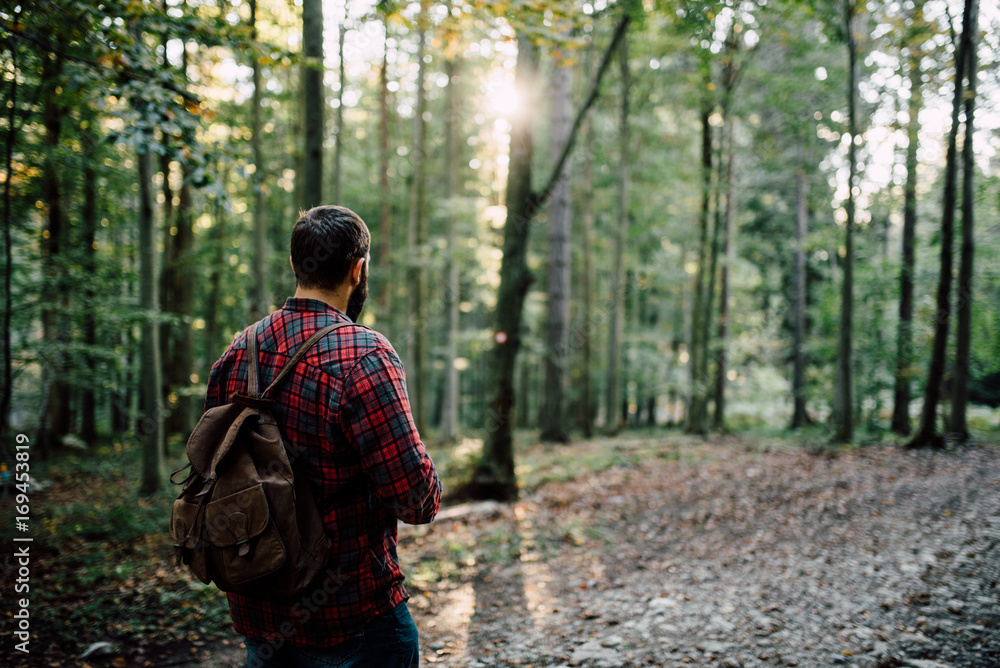 Man in a plaid shirt and backpack in the nature Man in a plaid shirt and backpack in the nature