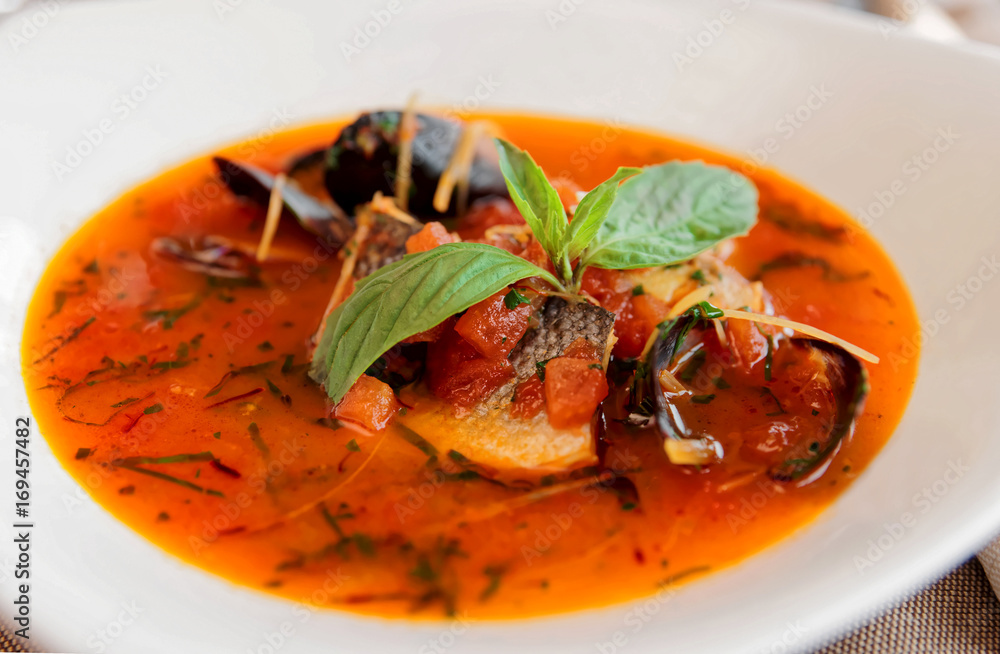 Seafood soup in porcelain plate, toned Seafood soup in porcelain plate, toned
