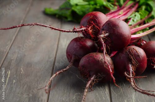 Bunch of fresh organic beets on rustic wooden table, selective focus, copy space