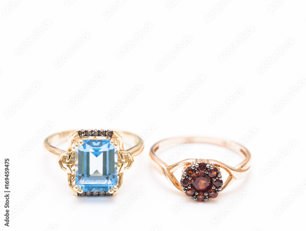 two gold rings with blue topaz and garnets two gold rings with blue topaz and garnets