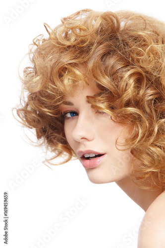 Young beautiful woman with curly hair over white background, copy space
