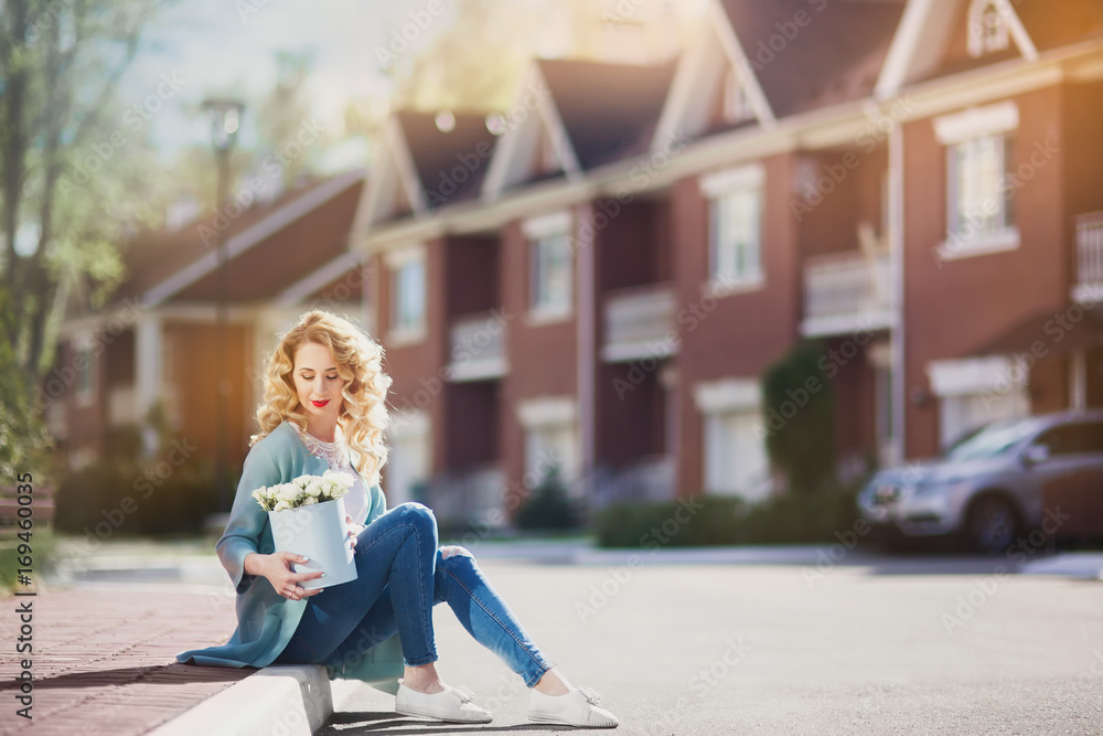 Beautiful woman with paper box of flowers