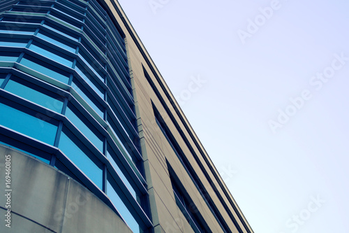 office building round corner skyscraper metal structure windows and concrete