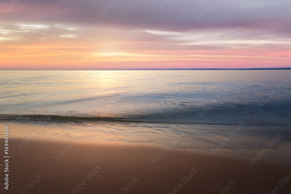 calm water on a background quiet sunset / wild beach dawn alone