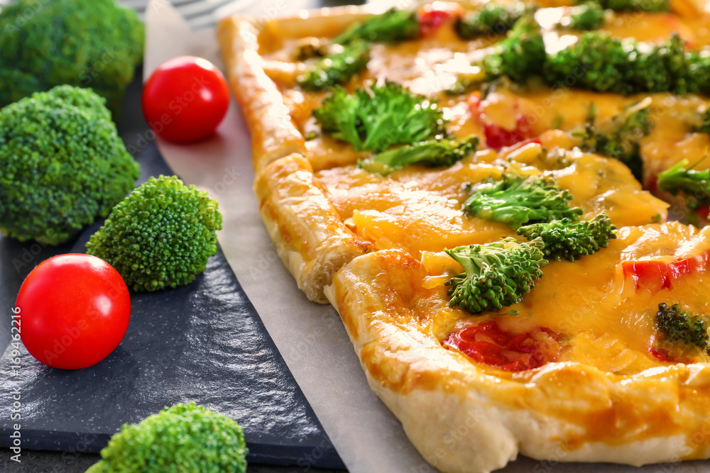 Traditional quiche with broccoli and cheese on table, close up Traditional quiche with broccoli and cheese on table, close up