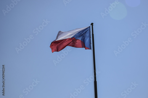 czech flag waving on clear sky with lense reflection
