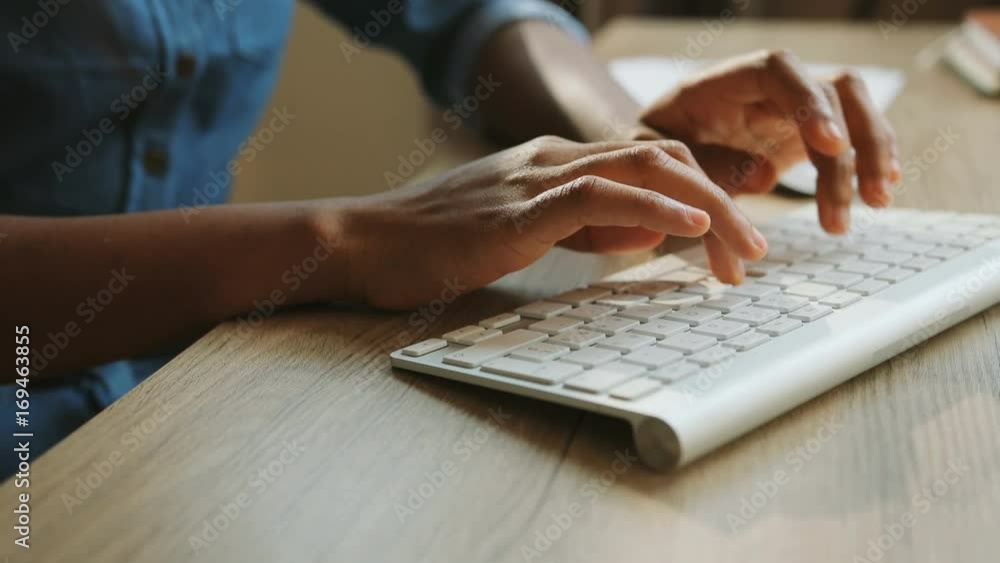 Close up shot of woman hand typing on the computer keyboard in the modern office at the table. Close up shot of woman hand typing on the computer keyboard in the modern office at the table.