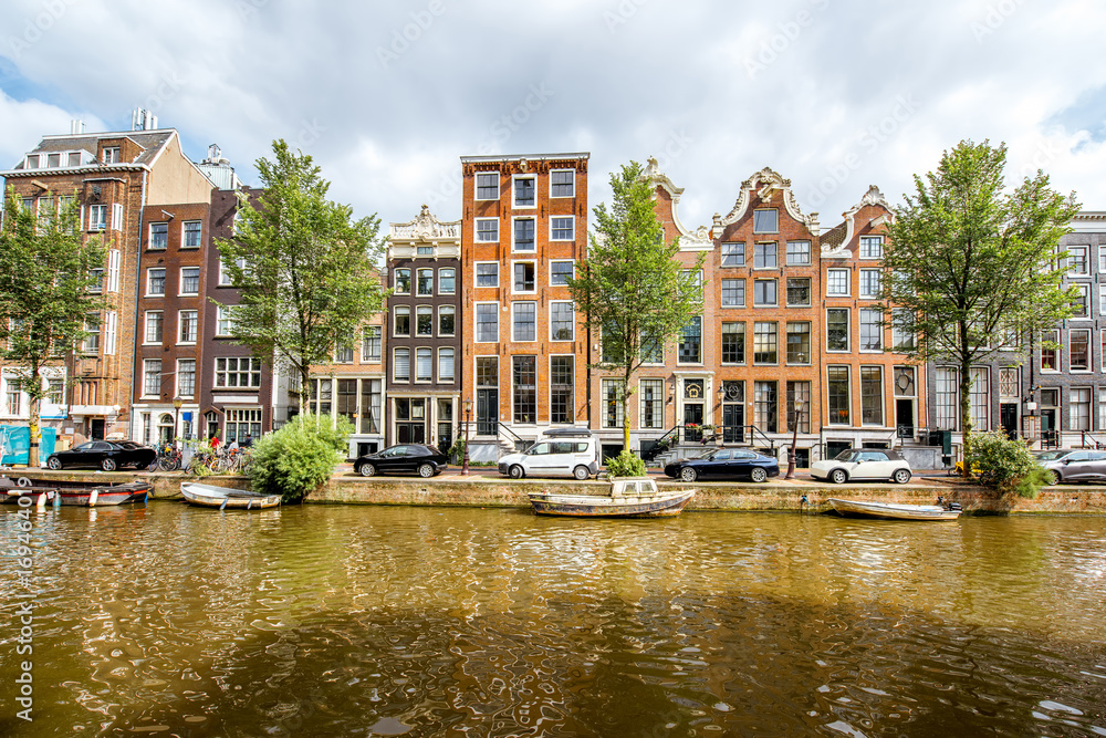 View on the beautiful old buildings and water channel in Amsterdam city