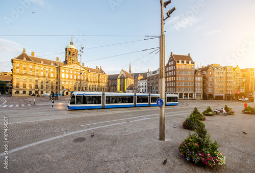Photography Morning view on the Dam square with Royal palace and tram in Amsterdam city duri