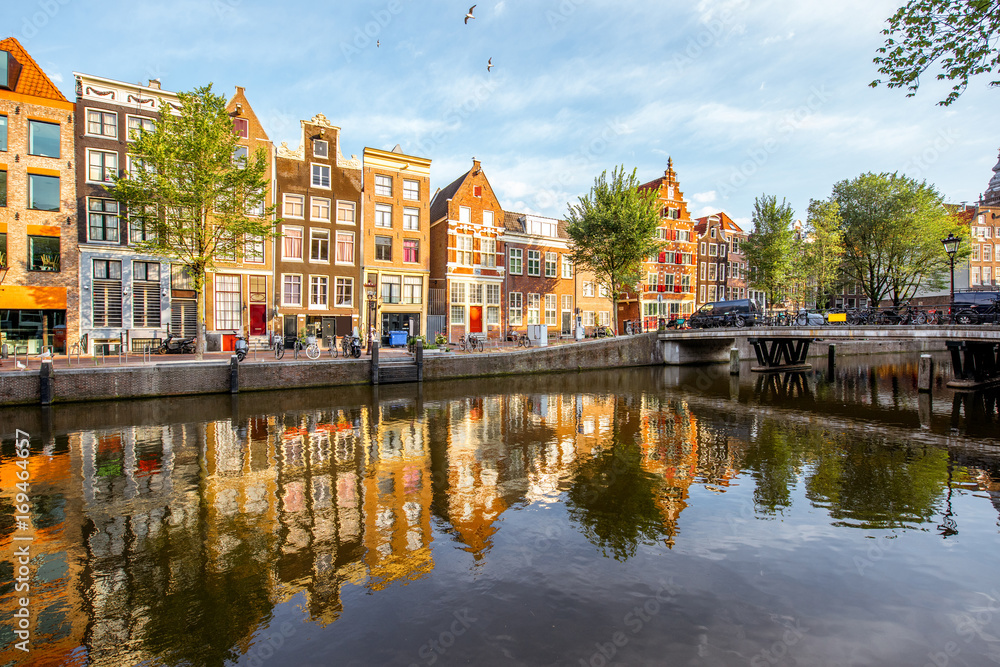 Morning view on the beautiful buildings and water channel in Amsterdam