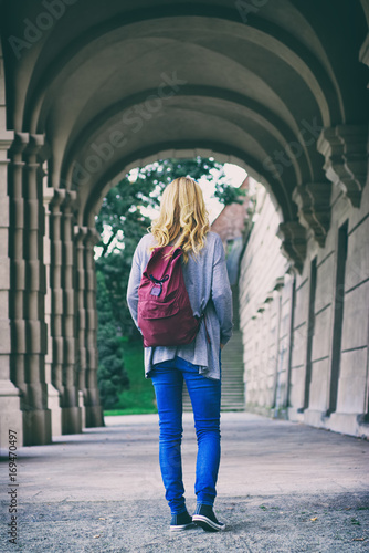 Young female tourist walks into a historic castle © encierro