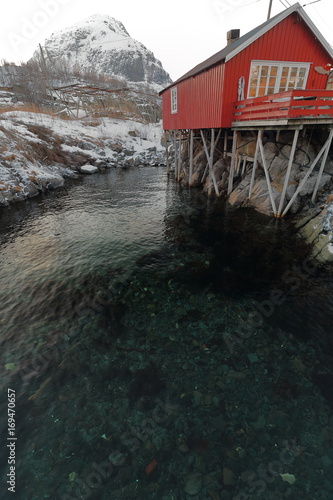 Red cottage-rorbu in A i Lofoten. Andstabben mountain background. Sorvagen-Moskenesoya-Nordland-Norway.0327-2 photo