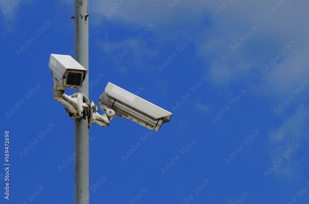 Security cameras on blue sky background Security cameras on blue sky background