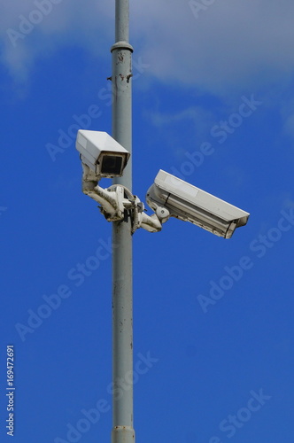 Security cameras on blue sky background - insecam