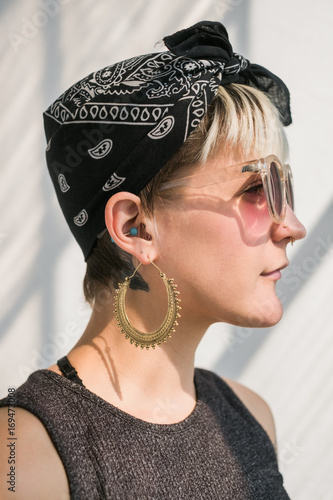 Side view of pretty girl in pink sunglasses. photo