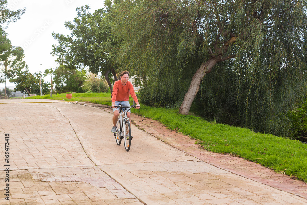 Young man riding a bicycle in a park