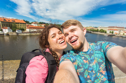 tourists couple taking selfie on city street. Vacation, love, travel and holiday concept.