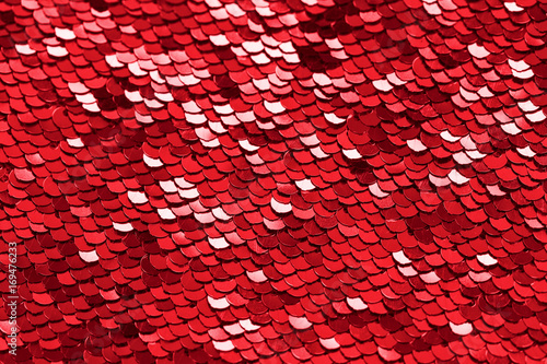Red sequins background or texture. Sparkling sequined textile