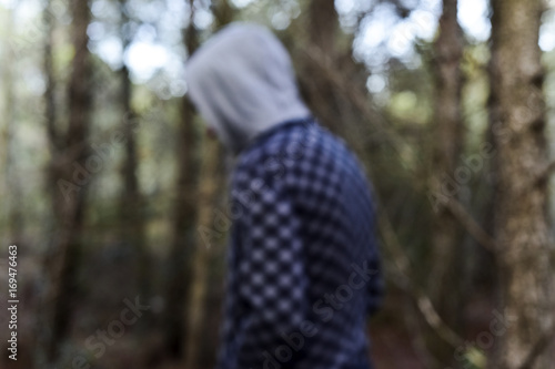 A young man walking in the woods