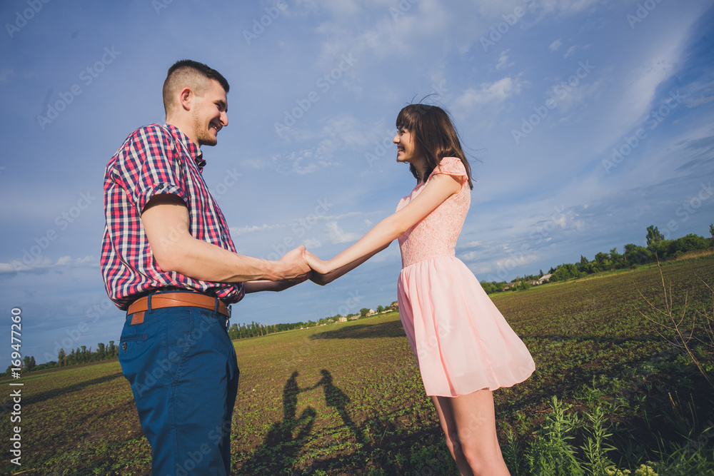 young couple in love together on nature in summer young couple in love together on nature in summer
