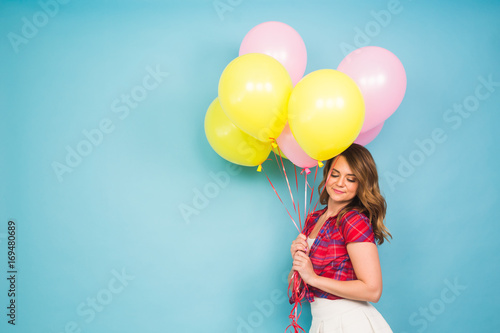 summer holidays, celebration, woman and people concept - happy woman with colorful balloons indoors, background with copyspace.
