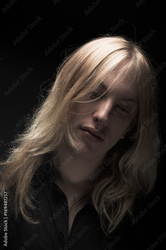 Young man with long blond hair Young man with long blond hair