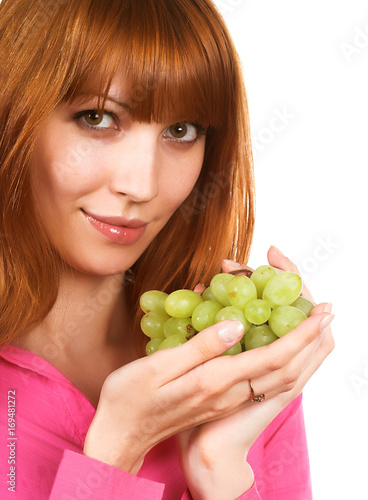 Beautiful young woman with green grape