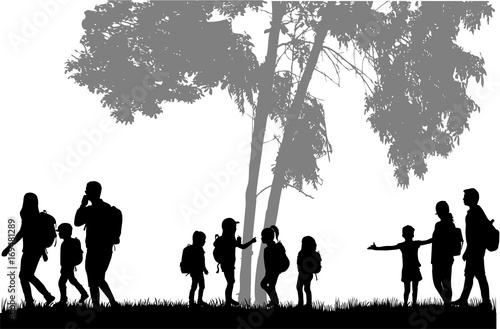 Family reaching with backpacks on a trip.