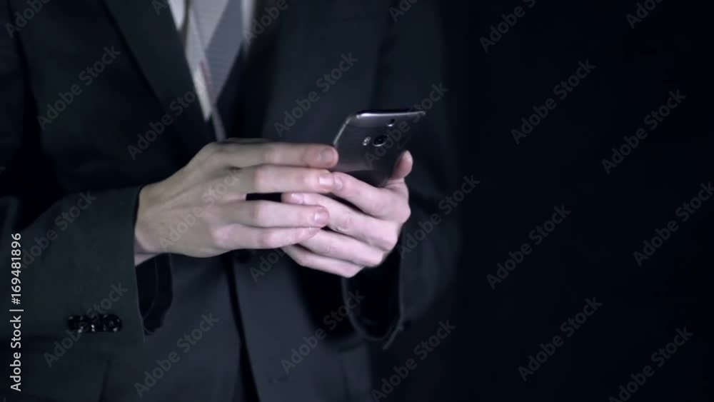 Businessman uses his smartphone Businessman uses his smartphone