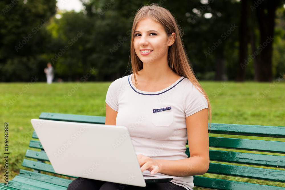 Woman using her laptop outdoors Woman using her laptop outdoors