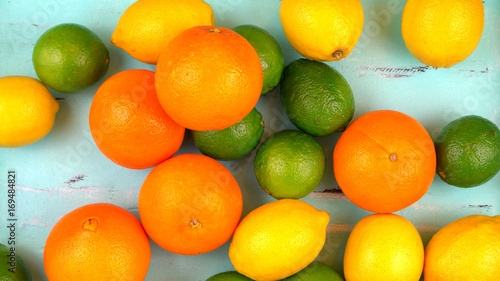 Mixed citrus fruit on aqua blue table