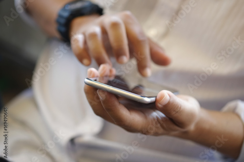 Close up of a man using mobile smartphone.