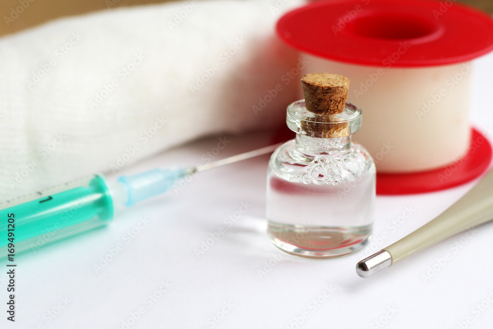 medicine bottle with syringe on white table medicine bottle with syringe on white table
