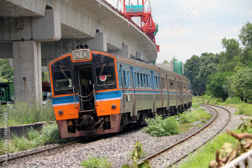 Train running on rails in Thailand, metal railway of train parallel with railway of Electric train.