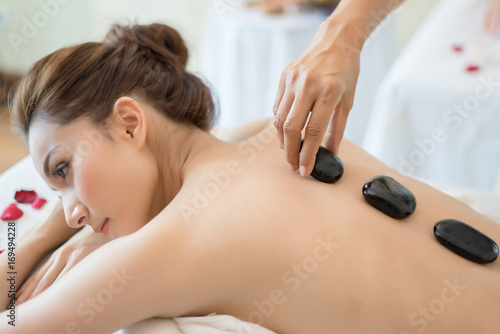 Young beautiful woman with healthy massage of body in the spa salon. Beauty concept.