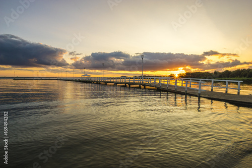 Sunset on the lake  wooden  white pier