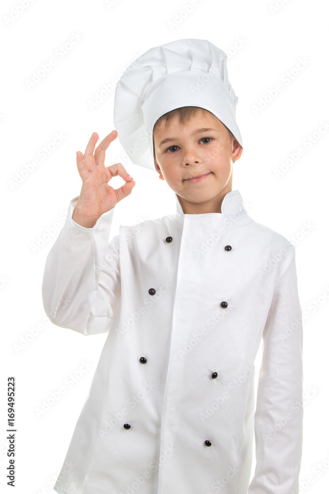 Cheerful handsome boy wearing chef uniform Cheerful handsome boy wearing chef uniform