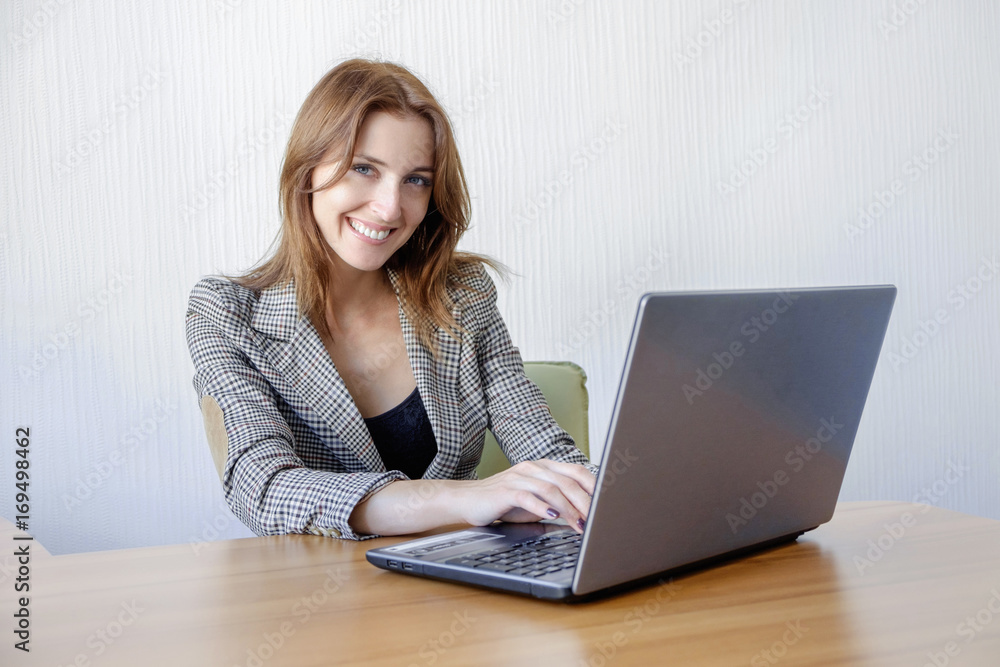Portrait of a young business woman using laptop at office Portrait of a young business woman using laptop at office